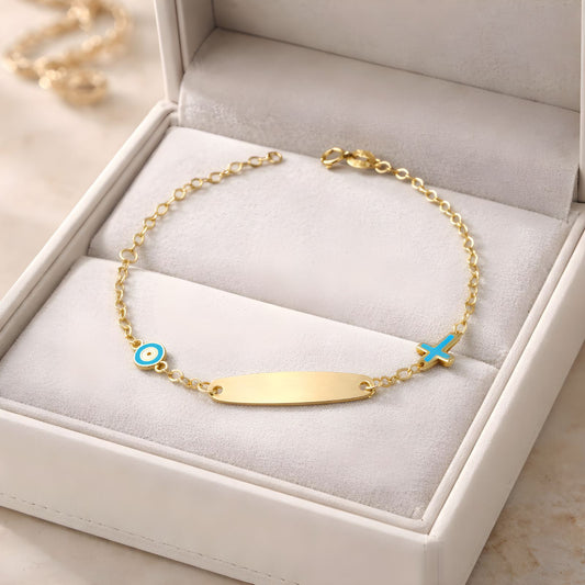 Children's 9k yellow gold ID bracelet featuring an blue eye charm and a cross charm, delicate baby jewelry.
